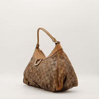 Sac Gucci Hobo vue de trois quarts toile monogrammée beige occasion authentique — AMANA Vintage