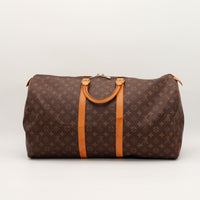 Louis Vuitton Keepall 55 vue de face côté anses cuir vachette caramel — AMANA Vintage
