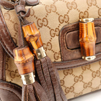 Detail accessoires bambou et pompon sac Gucci occasion authentique — AMANA Vintage