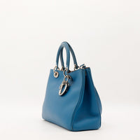Sac Dior Diorissimo bleu canard vue de trois quarts avec bandouliere — AMANA Vintage