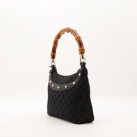 Vue de trois quarts Hobo Bambou Gucci noir clous dorés — AMANA Vintage