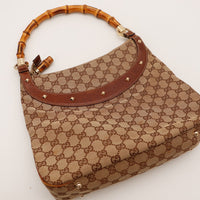 Gucci Hobo Bambou détail anse bambou et cuir marron posé à plat — AMANA Vintage